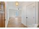 Bright entryway with light wood floors, white walls and a stylish light fixture at 7205 Church Rd, Taylorsville, NC 28681