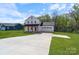 Beautiful two-story white farmhouse with a long driveway and attached garage at 7205 Church Rd, Taylorsville, NC 28681