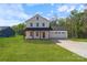 Charming two-story white farmhouse with a covered porch and attached garage at 7205 Church Rd, Taylorsville, NC 28681