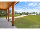 View from the covered front porch showing a well maintained green lawn at 7205 Church Rd, Taylorsville, NC 28681
