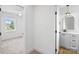 Hallway view to bedroom and bathroom that has modern vanity with gold mirror at 7205 Church Rd, Taylorsville, NC 28681