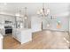 Open concept kitchen/living space with island, stainless appliances and wood-look floors at 7205 Church Rd, Taylorsville, NC 28681