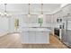 Light and airy kitchen showcasing quartz countertops, gray cabinets and stainless appliances at 7205 Church Rd, Taylorsville, NC 28681