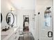 Bright primary bathroom with double sinks, quartz countertop, tiled floors, walk-in shower, and closet at 7324 Swans Run Rd, Charlotte, NC 28226