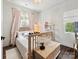 Cozy bedroom with soft lighting, wooden floors, a large window and stylish decor at 7324 Swans Run Rd, Charlotte, NC 28226