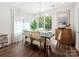 Bright dining room features a modern chandelier, wood floors, large windows and stylish furnishings at 7324 Swans Run Rd, Charlotte, NC 28226