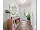 Bright entryway with modern light fixture, stylish decor, and wood-look flooring at 7324 Swans Run Rd, Charlotte, NC 28226