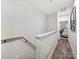 Bright hallway leading to the bedroom with wood floors and neutral walls at 7324 Swans Run Rd, Charlotte, NC 28226