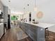 Spacious kitchen island with stylish pendant lights, seating, and modern appliances at 7324 Swans Run Rd, Charlotte, NC 28226