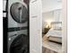 Modern laundry room adjacent to bedroom with a washer and dryer at 7324 Swans Run Rd, Charlotte, NC 28226