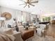 Inviting open-concept living space with stylish decor, a ceiling fan, and seamless flow to the kitchen at 7324 Swans Run Rd, Charlotte, NC 28226