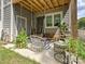 Relaxing covered patio with porch swings, outdoor seating and plants at 7324 Swans Run Rd, Charlotte, NC 28226