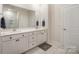 Bathroom offers a double vanity with ample storage, a framed mirror, and an enclosed shower at 7518 Porrera St, Charlotte, NC 28214
