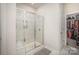 Modern bathroom featuring an enclosed shower with a glass door and a convenient built-in seat at 7518 Porrera St, Charlotte, NC 28214