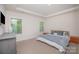 Cozy bedroom with tray ceilings, large windows, and neutral décor for a relaxing retreat at 7518 Porrera St, Charlotte, NC 28214