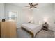 This bedroom features a ceiling fan, natural light, and neutral décor, creating a warm and inviting atmosphere at 7518 Porrera St, Charlotte, NC 28214