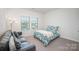 Cozy bedroom with a comfortable couch by the window, offering a relaxing space with natural light at 7518 Porrera St, Charlotte, NC 28214