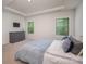This bedroom offers natural light, a ceiling fan, and neutral colors, making it a peaceful haven at 7518 Porrera St, Charlotte, NC 28214