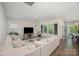 Bright, open living room featuring large windows, hardwood floors, and a comfortable sectional sofa at 7518 Porrera St, Charlotte, NC 28214