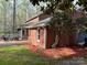 Brick home with a deck, manicured lawn, and lush landscaping at 815 21St Avenue Nw Dr, Hickory, NC 28601