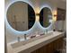 This bathroom has a sleek vanity with double, round, lighted mirrors at 815 21St Avenue Nw Dr, Hickory, NC 28601