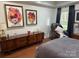 A primary bedroom with modern accent art and a wood dresser next to a massage chair at 815 21St Avenue Nw Dr, Hickory, NC 28601