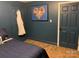 Comfortable bedroom with a picture, wood floors, and a blue accent wall at 815 21St Avenue Nw Dr, Hickory, NC 28601