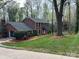 Charming two-story brick home featuring a well-manicured lawn and lush landscaping at 815 21St Avenue Nw Dr, Hickory, NC 28601