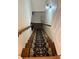 Stairwell with wood steps and a patterned runner with a decorative wall sconce at 815 21St Avenue Nw Dr, Hickory, NC 28601
