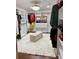 Spacious walk-in closet with ample shelves, drawers, and an ottoman at 815 21St Avenue Nw Dr, Hickory, NC 28601