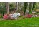 Beautifully landscaped yard with vibrant flowers and mature trees at 815 21St Avenue Nw Dr, Hickory, NC 28601