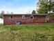 Spacious backyard, featuring a full brick exterior and well-maintained lawn at 827 Ford Dr, Lowell, NC 28098