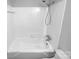Clean bathroom featuring a bathtub with white tile surround and updated fixtures at 827 Ford Dr, Lowell, NC 28098