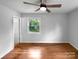 Bright bedroom featuring neutral walls, hardwood floors, and a window with outdoor views at 827 Ford Dr, Lowell, NC 28098