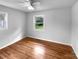 Cozy bedroom featuring hardwood floors, natural light, and a ceiling fan for comfort at 827 Ford Dr, Lowell, NC 28098