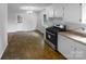 Spacious kitchen area featuring ample counter space, stainless steel range, and bright lighting at 827 Ford Dr, Lowell, NC 28098