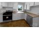 Bright kitchen with white cabinets, modern appliances and a view to the backyard at 827 Ford Dr, Lowell, NC 28098