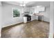 Kitchen with modern appliances, white cabinets and views to the backyard at 827 Ford Dr, Lowell, NC 28098