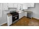 Well-equipped kitchen with stainless steel appliances, white cabinets, and tile backsplash at 827 Ford Dr, Lowell, NC 28098