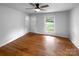 Bright living room featuring hardwood floors, ceiling fan, and a window offering natural light at 827 Ford Dr, Lowell, NC 28098