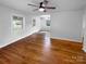 Bright, open room with hardwood flooring and natural light and views to a connected dining space at 827 Ford Dr, Lowell, NC 28098