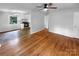 Open floor plan showcasing the kitchen and living area with hardwood flooring and neutral paint at 827 Ford Dr, Lowell, NC 28098