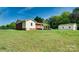 Expansive backyard featuring a charming brick ranch, wooden deck, and separate garage at 904 Sunbeam Dr, Lincolnton, NC 28092
