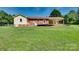 Large, well-maintained backyard showcasing a brick ranch, a wooden deck, and plenty of green space at 904 Sunbeam Dr, Lincolnton, NC 28092