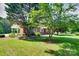 Charming brick home with a large yard and mature trees, featuring a covered carport at 904 Sunbeam Dr, Lincolnton, NC 28092