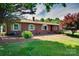 Classic brick ranch-style home featuring green shutters, mature landscaping, and a well-manicured lawn at 904 Sunbeam Dr, Lincolnton, NC 28092
