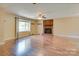 Open living room featuring a fireplace, large windows, and hardwood floors at 904 Sunbeam Dr, Lincolnton, NC 28092
