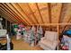 A cozy attic space with ample storage, featuring wooden beams, bins and tubs, plus a comfortable chair at 908 Gardenia St, Fort Mill, SC 29708