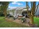 Charming backyard with a brick patio, comfortable seating, grill, and lush landscaping, perfect for outdoor relaxation at 908 Gardenia St, Fort Mill, SC 29708