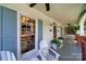 Inviting front porch featuring comfortable seating, ceiling fans, and decorative plants at 908 Gardenia St, Fort Mill, SC 29708